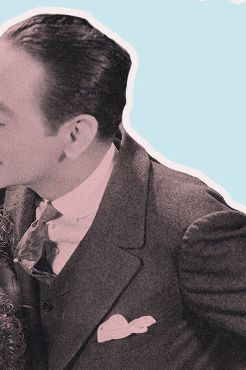 A photos from the 1920s of a man leaning in to kiss a woman