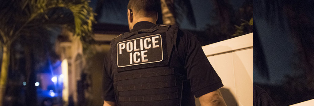 A photo of an officer with a vest that says "Police Ice" on it.