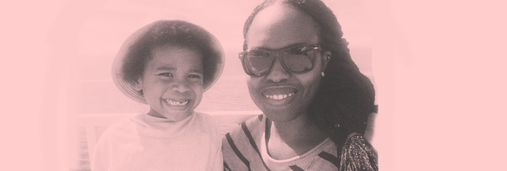 A photo of a Black mother taking a selfie with her Black son.