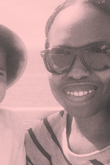 A photo of a Black mother taking a selfie with her Black son.