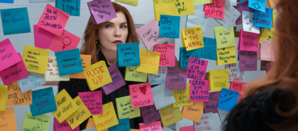A still from the series "Dietland" with a woman with red hair looking at post-it notes.