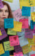 A still from the series "Dietland" with a woman with red hair looking at post-it notes.