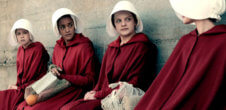 A still from the show, "The Handmaid's Tail." Women are wearing red robes and white bonnets.