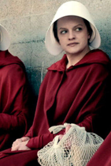 A still from the show, "The Handmaid's Tail." Women are wearing red robes and white bonnets.