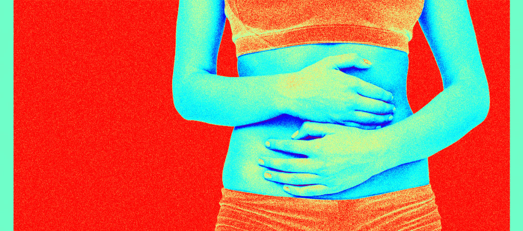 A photo of a woman holding her stomach