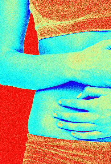 A photo of a woman holding her stomach