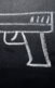 A photo of a gun drawn on a chalkboard