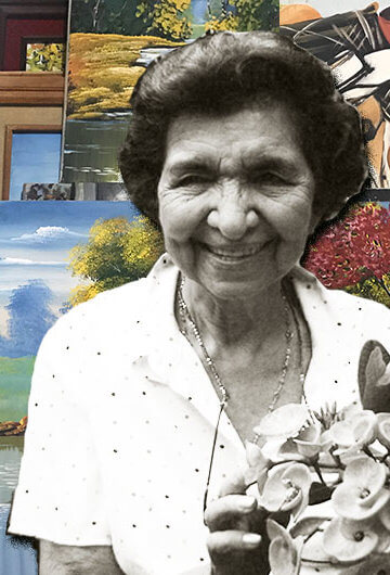 A photo of María Alva Consuelo Guevara Herrera de Rodriguez with paintings in the background.
