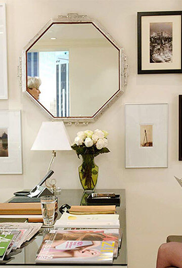 A still of Meryl Streep standing up and Anne Hathaway sitting down in "The Devil Wears Prada" in an office setting.