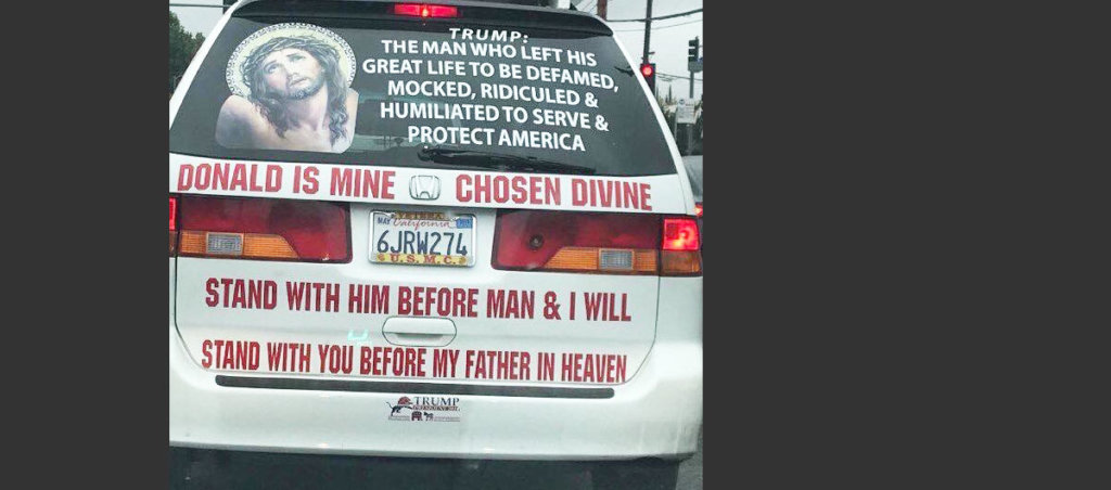 A photo of the back of the car that has a picture of Jesus Christ on it, as well as the text "Trump: The man who left his great life to be defamed, mocked, ridiculed, humiliated to serve & protect America. Donald is mine chosen divine. Stand with him before man & I will stand with you before my father in heaven."