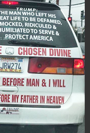 A photo of the back of the car that has a picture of Jesus Christ on it, as well as the text "Trump: The man who left his great life to be defamed, mocked, ridiculed, humiliated to serve & protect America. Donald is mine chosen divine. Stand with him before man & I will stand with you before my father in heaven."