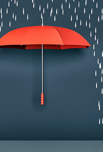 A collage of an umbrella with rain falling around it.