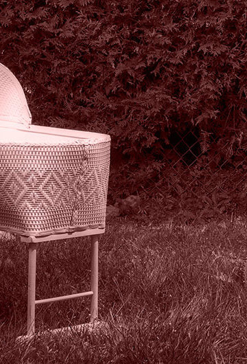 A photo of a small crib that is outside.