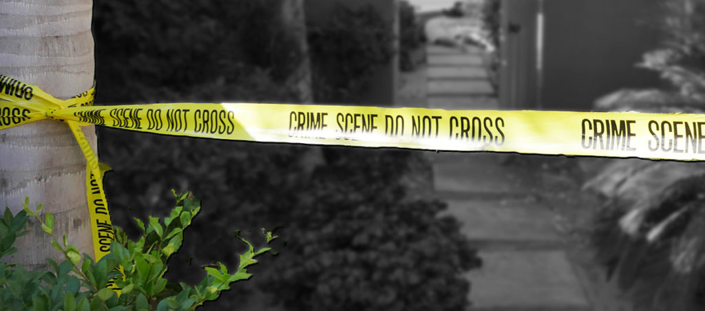 A photo of a street outside with a "Crime Scene Do Not Cross" rope set up.