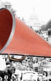 A megaphone on top of a photo of people protesting for women's rights.