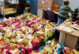 A photo of prepared baskets of food. One woman is likely preparing another in the background.