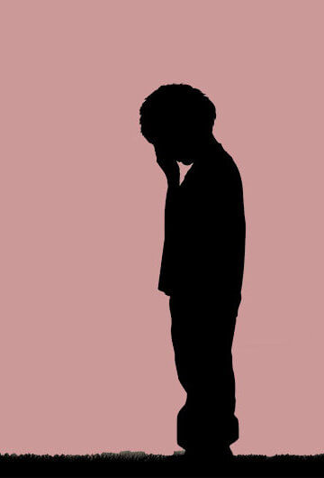 A kid painted in Black colors has its hand on its head. A parent also painted in black has their hands in a fist.