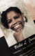 A pamphlet that says "In Loving Memory, Vickie L. Jones, February 2, 1951-October 24, 2018." There is also a photo of a Black woman smiling on the cover of the pamphlet.
