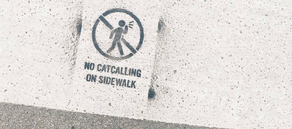 A photo of a sign that ays, "No catcalling on the sidewalk"