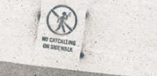 A photo of a sign that ays, "No catcalling on the sidewalk"