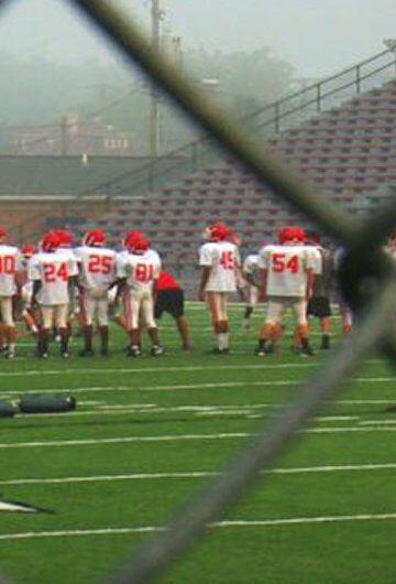 A photo of football players on a football field.