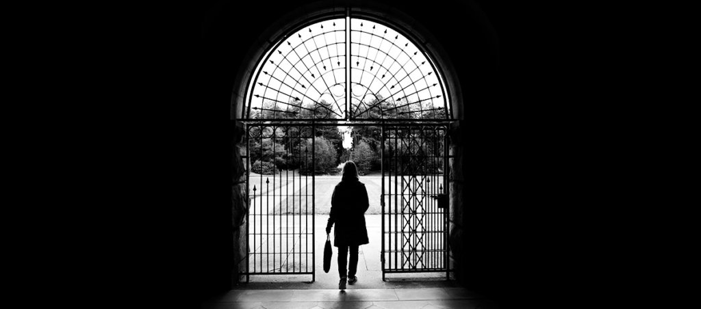 A photo of a woman walking out the doors.