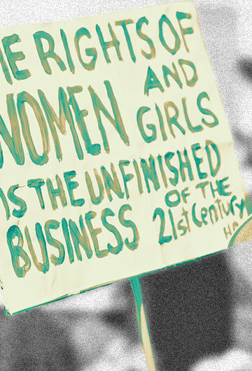 Photo from a protest with the sign "The Rights of Women and Girls Is The Unfinished Business of the 21st Century" is visible.