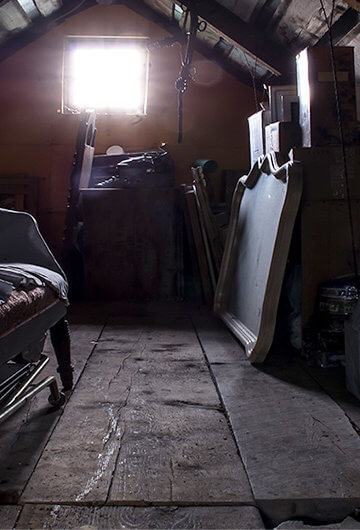 A photo of furniture in an attic or a basement.