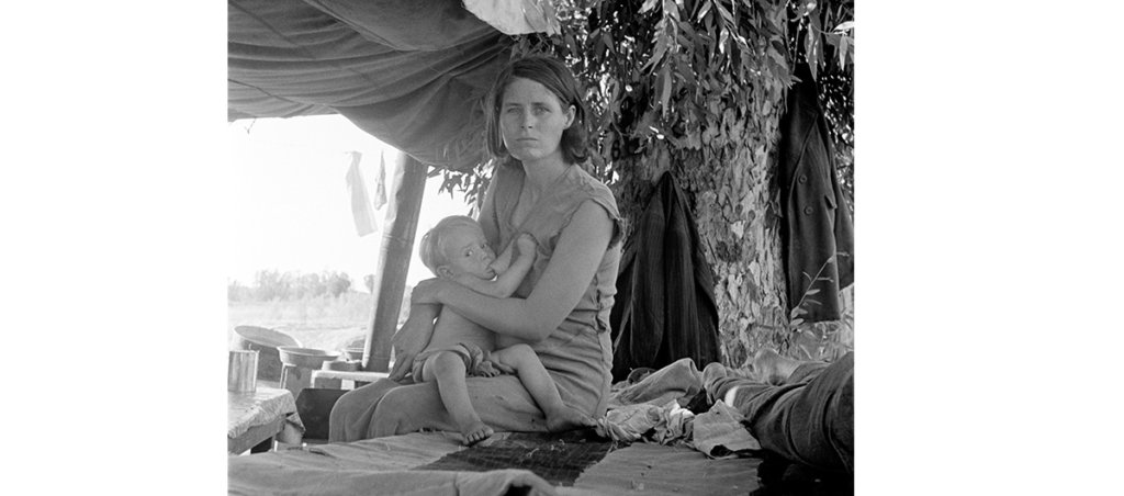 A black and white photo of a woman breastfeeding