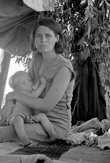 A black and white photo of a woman breastfeeding