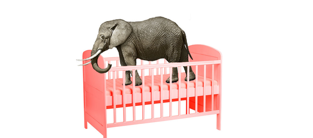 A collage of an elephant in a pink baby crib.