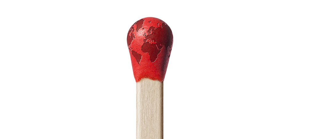 An image of the Earth on top of the bud of a match.