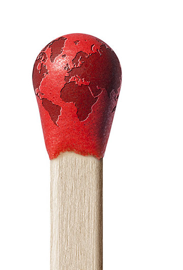 An image of the Earth on top of the bud of a match.