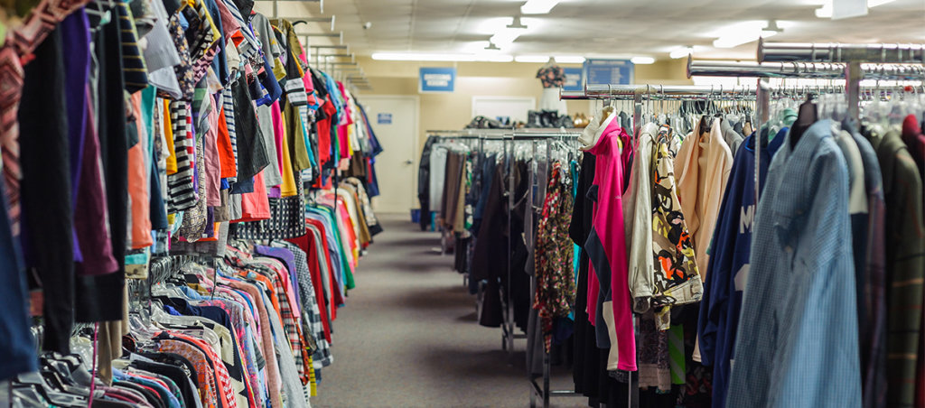 A photo of a thrift stories where colorful clothes are visible