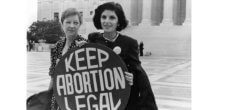 A black and white photo of two women holding a sign that says, "Keep Abortion Legal."
