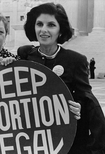 A black and white photo of two women holding a sign that says, "Keep Abortion Legal."