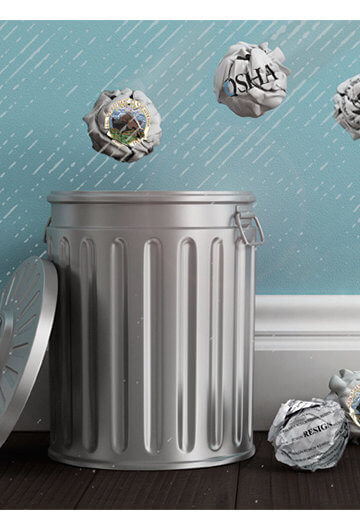 An image of crumpled up papers being thrown into a trashcan, some have missed.