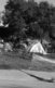 A black and white photo of tents that homeless people live in in a field