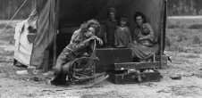 A photo of five people in a makeshift tent in the early 20th century.