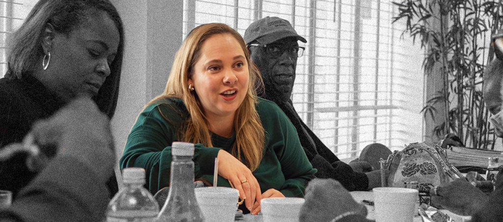 A photo of Sarah Riggs sitting on a panel