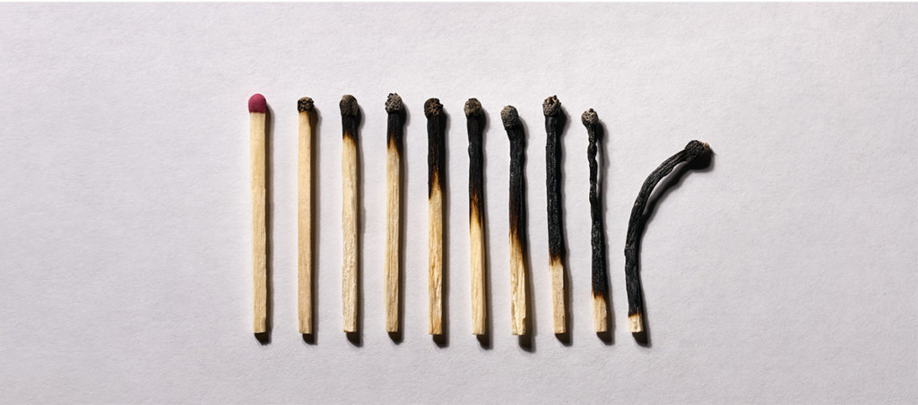 A photo of matches in various states of being burned.