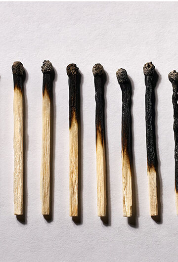 A photo of matches in various states of being burned.