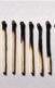A photo of matches in various states of being burned.