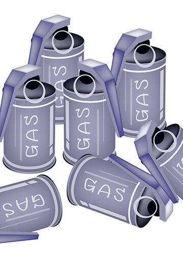 Several teargas canisters with the word gas on them