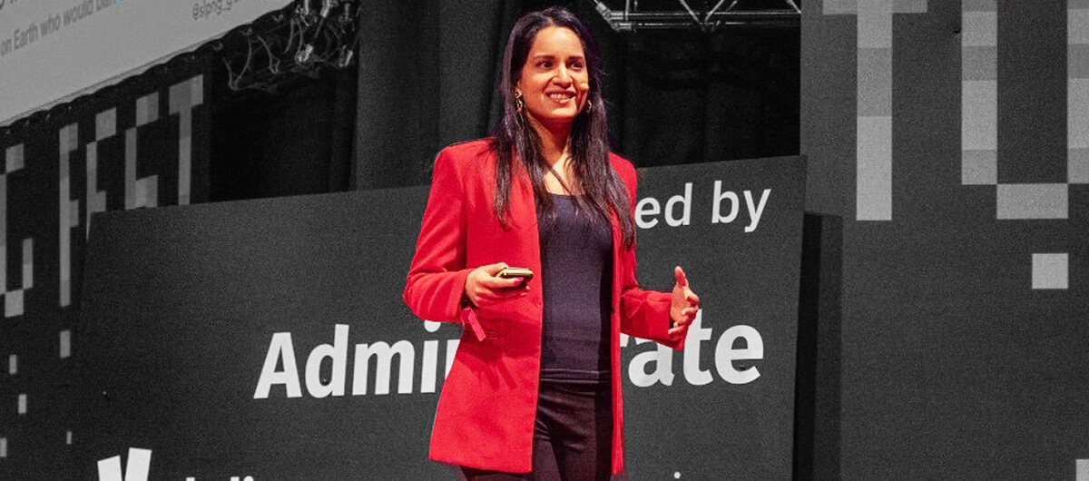 A photo of Nandini Jammi speaking onstage.