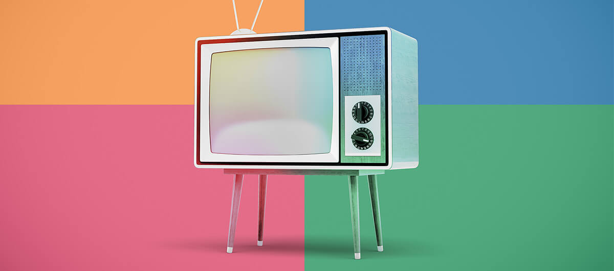 A collage of a television in front of different color blocks.