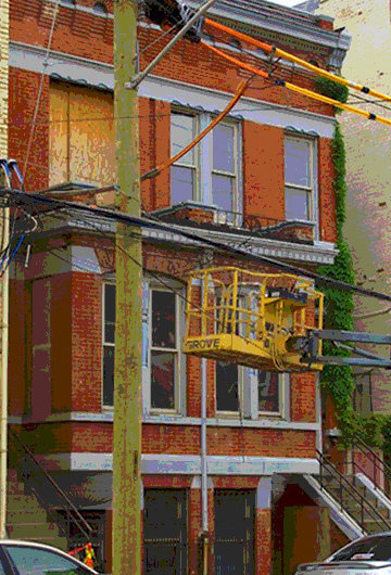 A photo of three houses with a construction in front of one of them.