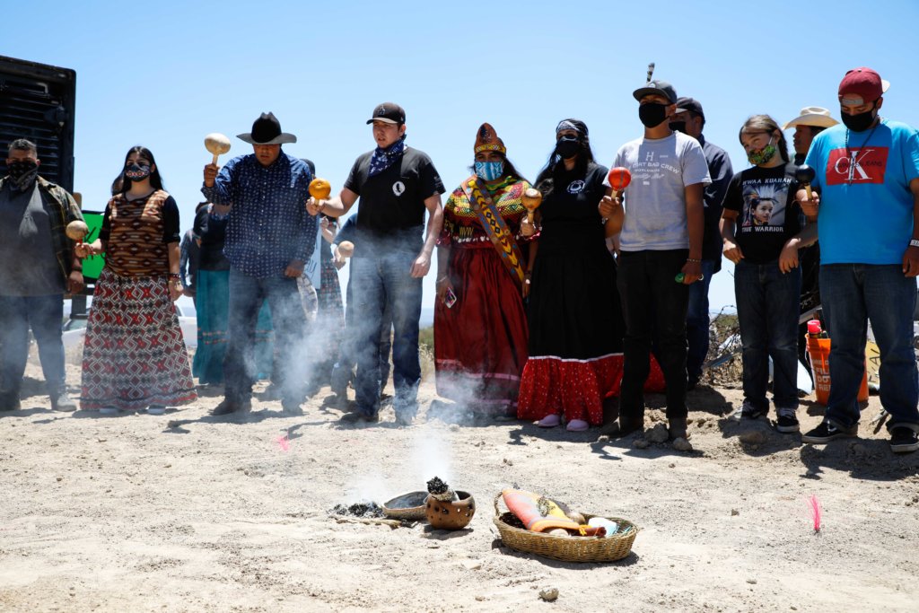 Kumeyaay Nation on the "Mexico" side pray while sage burns in the middle of the prayer circle.