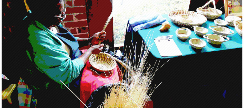 An image of a Black woman weaving a basket.