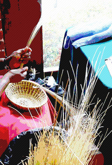 An image of a Black woman weaving a basket.